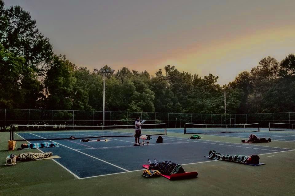 Yoga outdoors in the tennis court